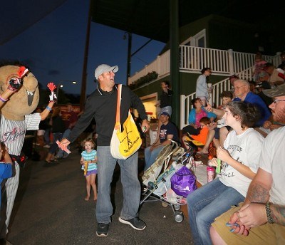 Matt Ossenfort hands out items to the crowd